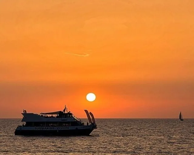 Sunset with boats off Es Vedrà