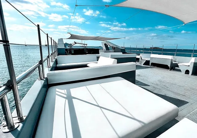 Boat deck with white sun loungers by the sea